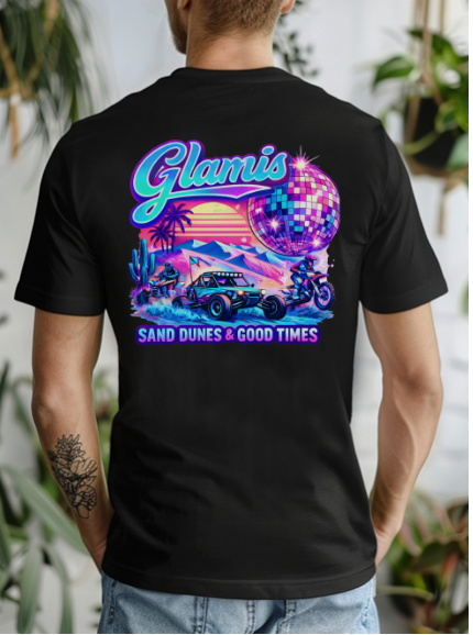 Person wearing a black t-shirt with a colorful graphic design featuring 'Glamis Sand Dunes & Good Times' text.